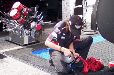 Top Fuel driver Hillary Will re-packs her dragster's parachute (Scarborough photo)
